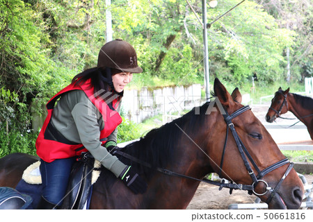 A woman riding a horse A woman riding a horse 50661816
