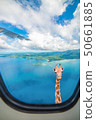 Giraffe is looking at plane window 50661885