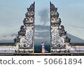 Man is standing in the gate of Lempuyang temple 50661894