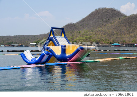 Inflatable childhood toys floating on dam in water Inflatable childhood toys floating on dam in water 50661901