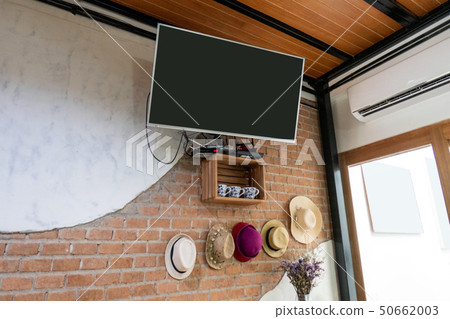 Flat TV hanging on brick wall 50662003