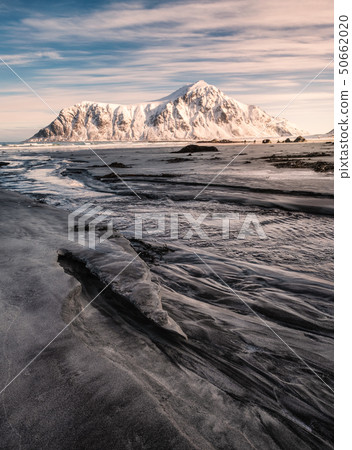 Snowy mountain on striped sand on coastline at Snowy mountain on striped sand on coastline at 50662020