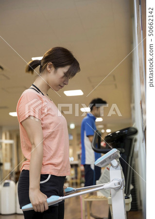 Sports gym image Woman on body fat scale 50662142
