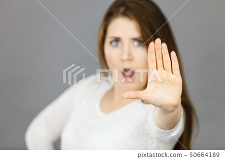 Angry apodicticity woman showing stop with hand Angry apodicticity woman showing stop with hand 50664189