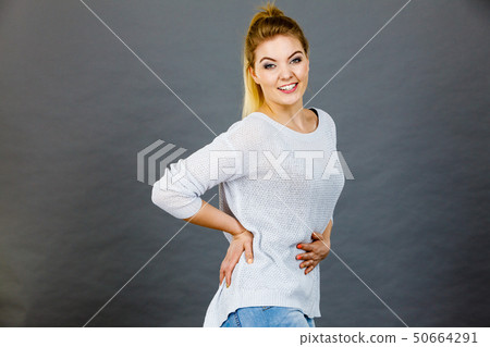 Happy woman touching her stomach and back Happy woman touching her stomach and back 50664291