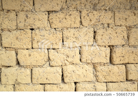 old yellow mud brick wall background 50665739