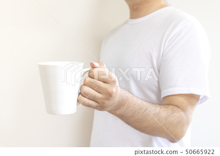 Man standing with a mug 50665922