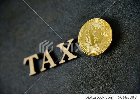 Bitcoin and wooden letters TAX on stone background Bitcoin and wooden letters TAX on stone background 50666398