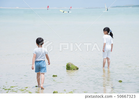 Children playing in the sea Children playing in the sea 50667323
