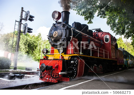 Steam locomotive blowing off the smoke 50668273
