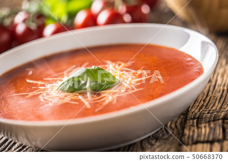 Hot tomato soup parmesan cheese and basil leave on Hot tomato soup parmesan cheese and basil leave on 50668370