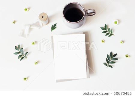 Floral lifestyle, stationery scene. Santini Chrysanthemum flowers, lentisk leaves and cup of coffee 50670495