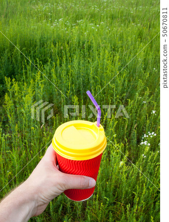 Hand holding plastic cup Hand holding plastic cup 50670811