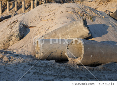 Concrete pipes (tubes) near the sand pile Concrete pipes (tubes) near the sand pile 50670813