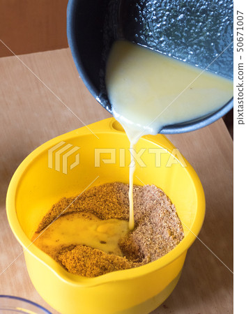 Add melted butter in baking cake.  50671007
