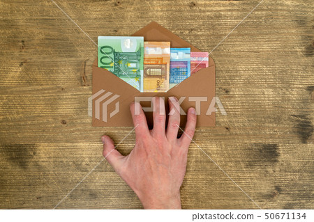 Hand takes an envelope with money Hand takes an envelope with money 50671134