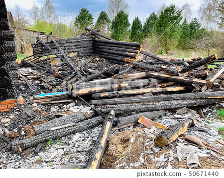 Burnt wooden house 50671440