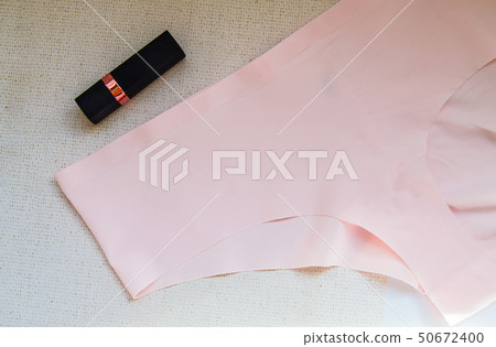 Flat lay women's accessories - underwear and cosmetics.The view from the top women's pink bikini 50672400
