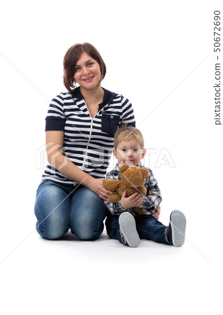 young beautiful mother in jeans sitting with her young beautiful mother in jeans sitting with her 50672690