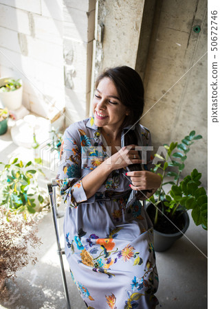 Beautiful young lady artist sitting in her bohemian artistic studio loft 50672746