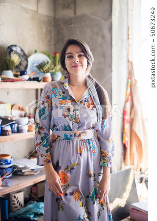 Beautiful lady artist standing in her studio, creative business owner Beautiful lady artist standing in her studio, creative business owner 50673249