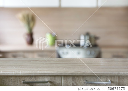 Blurred kitchen background with wooden tabletop. 50673275