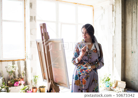 Young beautiful lady painter in dress, woman artist painting Young beautiful lady painter in dress, woman artist painting 50673342