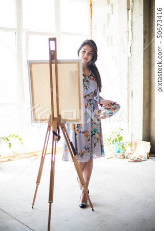 Young beautiful lady painter in dress, woman artist painting Young beautiful lady painter in dress, woman artist painting 50673416