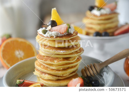 Close-up, Decorating a stack of pancakes. Close-up, Decorating a stack of pancakes. 50673571