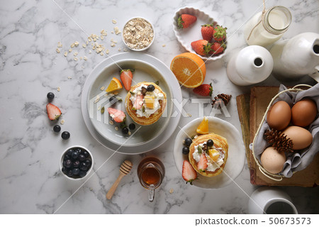 A white plate with homemade pancakes. top view A white plate with homemade pancakes. top view 50673573