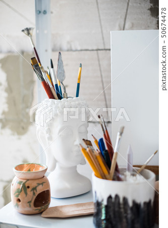 Pencils and brushes on shelf in artistic studio Pencils and brushes on shelf in artistic studio 50674478