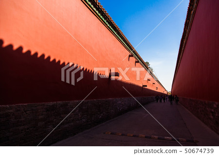 Red walls with yellow tiles (on the top) on each side of a road in the Forbidden City, Beijing Red walls with yellow tiles (on the top) on each side of a road in the Forbidden City, Beijing 50674739