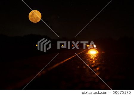 Small light on the road in the night Small light on the road in the night 50675170
