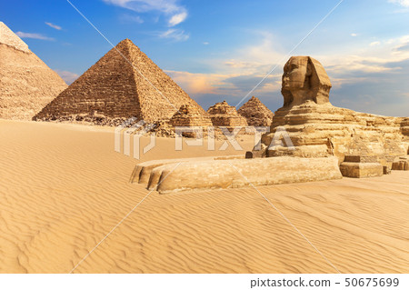 The Sphinx of Giza next to the Pyramids in the desert, Egypt The Sphinx of Giza next to the Pyramids in the desert, Egypt 50675699