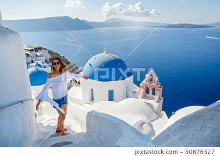 Beautiful young woman against  Santorini 50676327