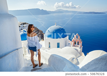 Beautiful young woman against  Santorini 50676328