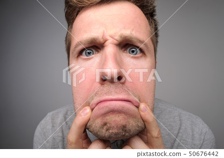 Young caucasian man is exhausted with work or tired. Young caucasian man is exhausted with work or tired. 50676442