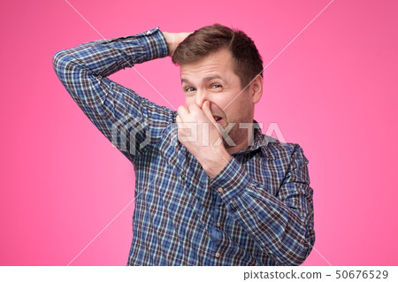 Caucasian, young man is worried and shocked because of sweating stain Caucasian, young man is worried and shocked because of sweating stain 50676529