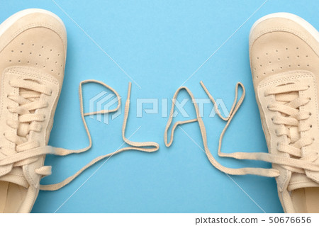 Women sneakers with laces in play text. 50676656