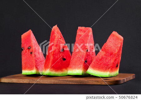 Four triangular wedges of watermelon 50676824