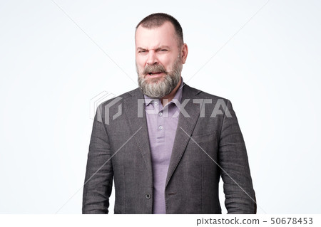 Shocked mature man looking at something unpleasant and bad 50678453