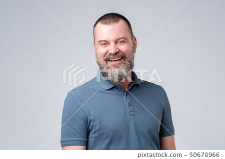 Caucasian mature man laughing on funny joke. 50678966