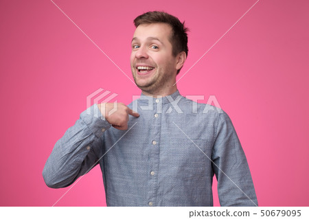 Man looking confident with smile on face pointing with fingers at himself 50679095