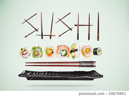 Pieces of delicious japanese sushi frozen in the air. Pieces of delicious japanese sushi frozen in the air. 50679461