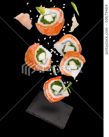 Pieces of delicious japanese sushi frozen in the air. Pieces of delicious japanese sushi frozen in the air. 50679464