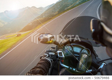 Moto racer riding on mountain road, travel to Europe. Moto racer riding on mountain road, travel to Europe. 50679466