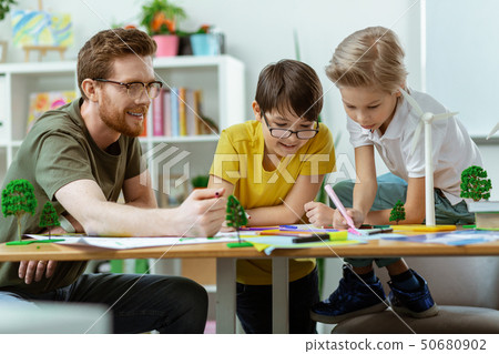 Concentrated little boys being interested in drawing project 50680902