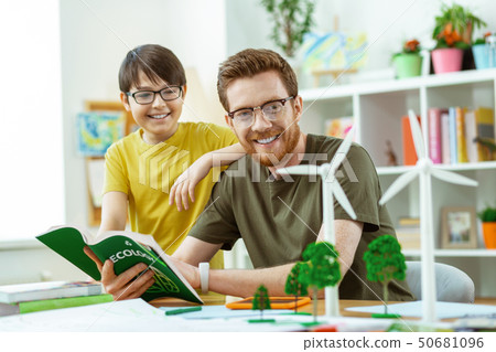 Joyful curious teacher explaining his student opportunities of windmills 50681096