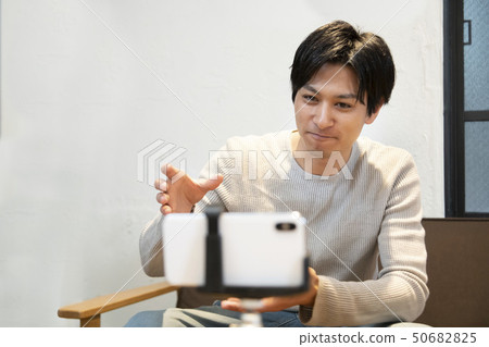 Men shooting videos with a smartphone 50682825