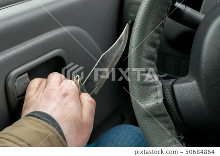 View of the knife in the hand of the driver View of the knife in the hand of the driver 50684864